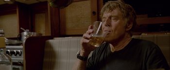 Movie still from “All Is Lost” (2013), directed by J.C. Chandor – A man is drinking a glass of wine; Close Up shot, Low angle