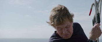 Movie still from “All Is Lost” (2013), directed by J.C. Chandor – An older woman is looking down at the sky; Close Up shot, Low angle