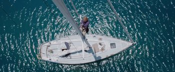 Movie still from “All Is Lost” (2013), directed by J.C. Chandor – An aerial view of a person on a sail boat in the ocean; Extreme Wide shot, Overhead angle