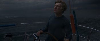 Movie still from “All Is Lost” (2013), directed by J.C. Chandor – A man on a sailboat in the ocean at night; Close Up shot, Low angle