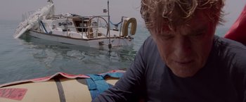 Movie still from “All Is Lost” (2013), directed by J.C. Chandor – A man sitting on a boat in the water; Close Up shot, Low angle