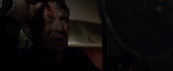 Movie still from “All Is Lost” (2013), directed by J.C. Chandor – A person with a bandage on his face; Close Up shot, Over the shoulder angle