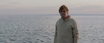 Movie still from “All Is Lost” (2013), directed by J.C. Chandor – A man standing in front of a body of water; Medium shot, Low angle