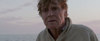 Movie still from “All Is Lost” (2013), directed by J.C. Chandor – An older man with a beard and a white shirt; Close Up shot, Low angle