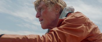 Movie still from “All Is Lost” (2013), directed by J.C. Chandor – A person wearing an orange jacket; Close Up shot, Low angle