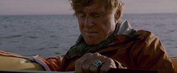 Movie still from “All Is Lost” (2013), directed by J.C. Chandor – An older man looking down at a ring on his finger; Close Up shot, Low angle
