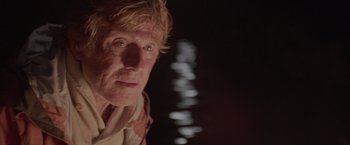 Movie still from “All Is Lost” (2013), directed by J.C. Chandor – A person wearing a white shirt; Close Up shot, Low angle
