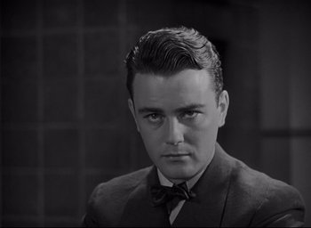 Movie still from “All Quiet on the Western Front” (1930), directed by Lewis Milestone – A man in a suit and bow tie; Close Up shot, Low angle