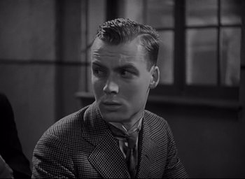 Movie still from “All Quiet on the Western Front” (1930), directed by Lewis Milestone – A black and white photo of a man in a suit and tie; Close Up shot, Low angle