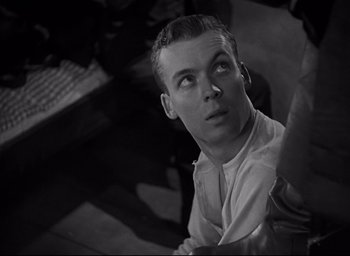 Movie still from “All Quiet on the Western Front” (1930), directed by Lewis Milestone – Black and white photograph of a man looking up; Close Up shot, High angle