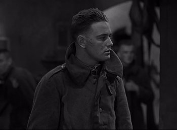Movie still from “All Quiet on the Western Front” (1930), directed by Lewis Milestone – Black and white photograph of a man in a military uniform; Close Up shot, Low angle