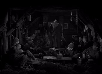 Movie still from “All Quiet on the Western Front” (1930), directed by Lewis Milestone – A group of men sitting in a room; Wide shot, High angle
