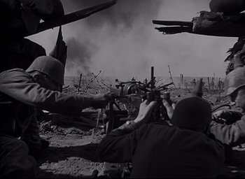 Movie still from “All Quiet on the Western Front” (1930), directed by Lewis Milestone – A black and white photo of soldiers in a field; Wide shot, Over the shoulder angle