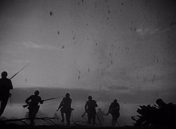 Movie still from “All Quiet on the Western Front” (1930), directed by Lewis Milestone – A black and white photo of a group of men holding guns; Extreme Wide shot, Low angle