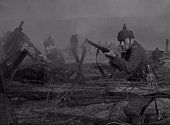 Movie still from “All Quiet on the Western Front” (1930), directed by Lewis Milestone – A black and white photo of soldiers in a field; Medium shot, Low angle