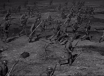 Movie still from “All Quiet on the Western Front” (1930), directed by Lewis Milestone – A black and white photo of a group of soldiers; Wide shot, High angle