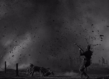 Movie still from “All Quiet on the Western Front” (1930), directed by Lewis Milestone – A man in a black suit and a horse in a field; Wide shot, Low angle