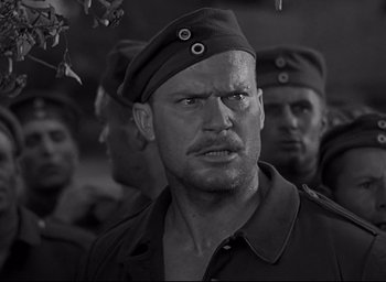 Movie still from “All Quiet on the Western Front” (1930), directed by Lewis Milestone – Black and white photograph of a man in a military uniform; Close Up shot, Over the shoulder angle