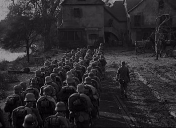 Movie still from “All Quiet on the Western Front” (1930), directed by Lewis Milestone – A black - and - white photo of a large group of soldiers; Wide shot, High angle