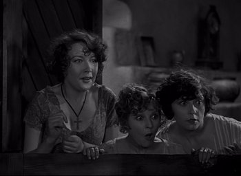 Movie still from “All Quiet on the Western Front” (1930), directed by Lewis Milestone – A group of people standing next to each other in a room; Medium shot, Low angle