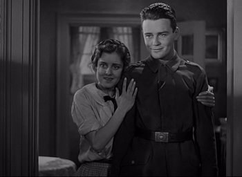 Movie still from “All Quiet on the Western Front” (1930), directed by Lewis Milestone – A man and a woman posing for a picture; Medium shot, Low angle