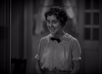 Movie still from “All Quiet on the Western Front” (1930), directed by Lewis Milestone – A black - and - white photo of a woman smiling; Close Up shot, Low angle
