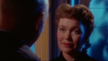 Movie still from “All That Heaven Allows” (1955), directed by Douglas Sirk – An older woman is looking at a younger man; Close Up shot, Over the shoulder angle