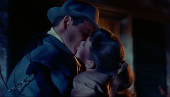 Movie still from “All That Heaven Allows” (1955), directed by Douglas Sirk – A man and a woman are kissing in the dark; Close Up shot, Low angle