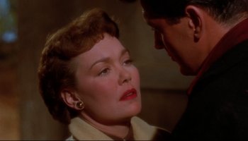 Movie still from “All That Heaven Allows” (1955), directed by Douglas Sirk – An older woman is looking down at a younger man; Close Up shot, Over the shoulder angle