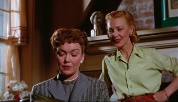 Movie still from “All That Heaven Allows” (1955), directed by Douglas Sirk – Two women are standing next to each other; Medium shot, Low angle
