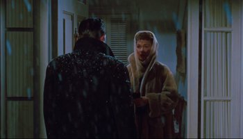 Movie still from “All That Heaven Allows” (1955), directed by Douglas Sirk – A woman in a fur coat talking to a man in a black jacket; Medium shot, Over the shoulder angle