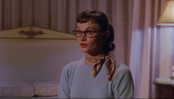 Movie still from “All That Heaven Allows” (1955), directed by Douglas Sirk – A woman wearing glasses and a neck scarf; Close Up shot, Over the shoulder angle