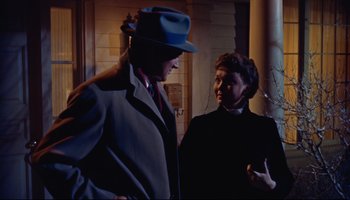 Movie still from “All That Heaven Allows” (1955), directed by Douglas Sirk – A man and a woman standing next to each other; Medium shot, Low angle