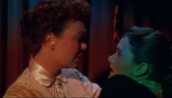 Movie still from “All That Heaven Allows” (1955), directed by Douglas Sirk – An older woman and a young boy looking at each other; Close Up shot, High angle