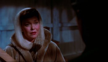 Movie still from “All That Heaven Allows” (1955), directed by Douglas Sirk – An older woman wearing a fur coat and a fur hat; Close Up shot, Over the shoulder angle