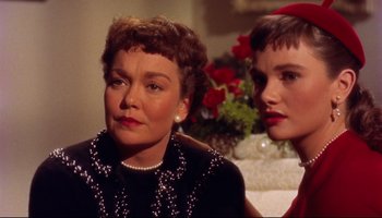 Movie still from “All That Heaven Allows” (1955), directed by Douglas Sirk – Two women sitting next to each other in a room; Close Up shot, Low angle