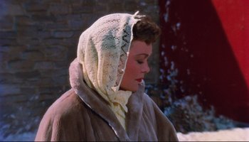 Movie still from “All That Heaven Allows” (1955), directed by Douglas Sirk – A woman wearing a scarf and a fur coat; Close Up shot, High angle