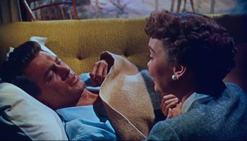 Movie still from “All That Heaven Allows” (1955), directed by Douglas Sirk – An older couple laying on a couch looking at each other; Medium shot, Overhead angle