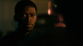 Movie still from “Snowfall” (2017), directed by Hiro Murai – A person wearing a black shirt; Close Up shot, Over the shoulder angle