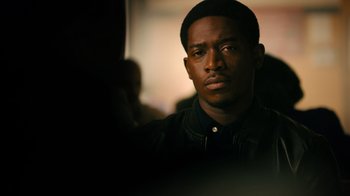 Movie still from “Snowfall” (2017), directed by Hiro Murai – A person wearing a black jacket; Close Up shot, Over the shoulder angle