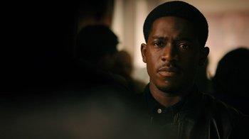 Movie still from “Snowfall” (2017), directed by Hiro Murai – A person wearing a black shirt; Close Up shot, Over the shoulder angle