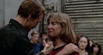 Movie still from “All That Jazz” (1979), directed by Bob Fosse – A man and a woman standing next to each other in front of a crowd of onlookers; Close Up shot, Over the shoulder angle