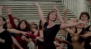 Movie still from “All That Jazz” (1979), directed by Bob Fosse – A group of people standing around each other in a room; Medium shot, Low angle