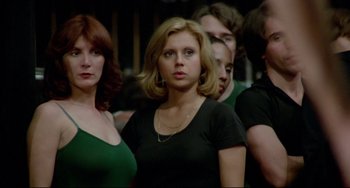 Movie still from “All That Jazz” (1979), directed by Bob Fosse – A group of people standing next to each other in a room; Close Up shot, Low angle