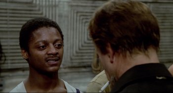 Movie still from “All That Jazz” (1979), directed by Bob Fosse – Two men talking to each other in front of a building; Close Up shot, Over the shoulder angle