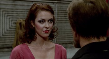 Movie still from “All That Jazz” (1979), directed by Bob Fosse – A woman in a pink dress looking at a man in a black suit; Close Up shot, Over the shoulder angle