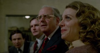 Movie still from “All That Jazz” (1979), directed by Bob Fosse – A man and a woman and a man wearing glasses; Close Up shot, Low angle