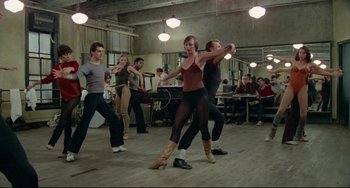 Movie still from “All That Jazz” (1979), directed by Bob Fosse – A group of young people dancing in a room; Wide shot, High angle