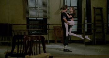 Movie still from “All That Jazz” (1979), directed by Bob Fosse – A man and a woman are dancing in a room; Wide shot, Low angle