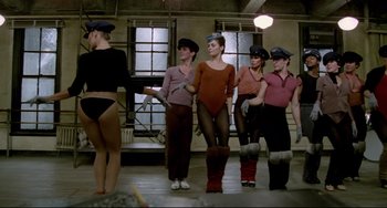 Movie still from “All That Jazz” (1979), directed by Bob Fosse – A group of women standing next to each other in a room; Wide shot, Low angle
